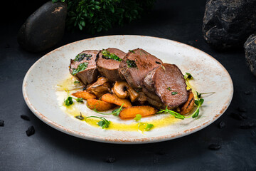 Beef medallions with mushroom sauce, sliced fried potato and microgreens.