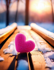 Pink heart on a wooden bench in the winter forest with sunset sun. Love concept.	