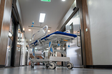A hospital bed is in the hallway of a hospital