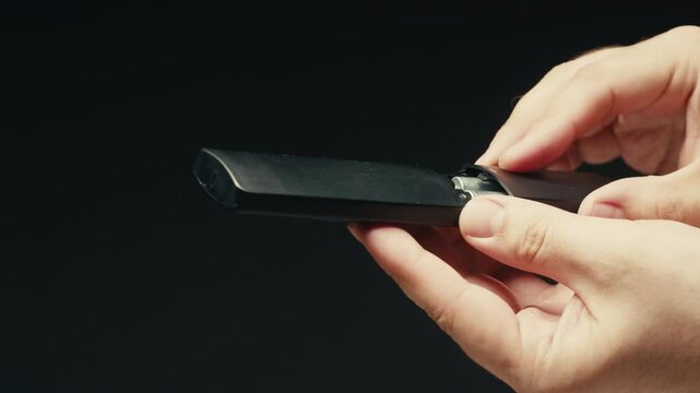 Adding silver batteries AA and AAA in remote controller TV close-up. Batteries are common in portable electronic devices. An AA battery is composed of a single electrochemical cell that may be either