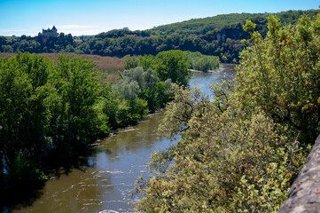 Driving along Dordogne river near   .La Roque-Gageac village located in Dordogne department in...