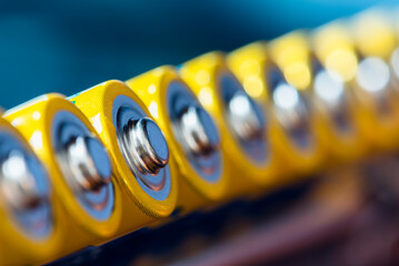 Alkaline AA batteries close-up arranged in a row