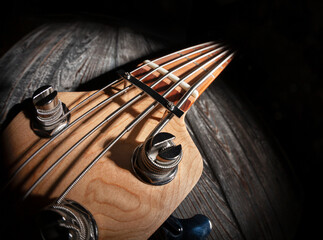 bass guitar headstock tuning post fisheye on wood background