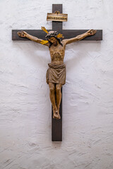 The historic wooden crucifix on a white wall.