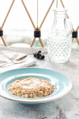 creamy Italian risotto served in a stylish bowl, showcasing its rich texture and garnished with a drizzle of sauce, perfect for a gourmet meal.