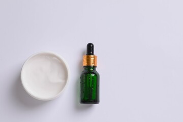 Skin care with cosmetic facial serum with moisturizing cream