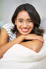 Fototapeta premium Portrait, home and woman on sofa, comfort and relax with happiness, calm and weekend break. Face, apartment and person on couch, cheerful or peace with interior, wellness and house with smile or girl