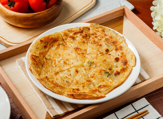 Crispy Scallion Pancake or paratha in plate served in wooden tray side view of taiwan food
