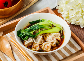 Spicy Szechuan Wonton Soup in bowl served in wooden tray side view of taiwan food
