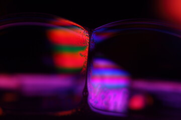 Red and purple reflections of the liquid in macro, flat liquid surface