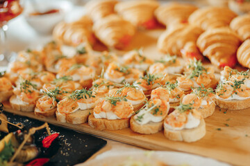 Appetizer toasted bruschetta with shrimps on wooden board
