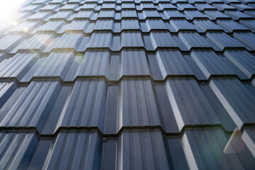 A CloseUp View of Metal Roof Tiles That Captures the Beautiful Reflection of Sunlight on Their Surface