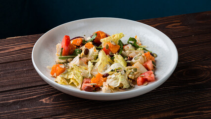 Green salad with pumpkin, tomatoes, beans, onions, lettuce and pumpkin seeds.