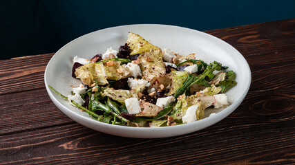 Green salad with beets, cheese, walnuts, lettuce and arugula.