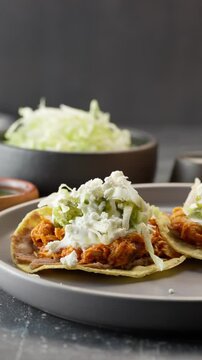 Vertical video, mexican Chicken Tinga Tostadas with lettuce and crumbled cheese