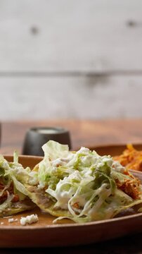 Vertical slow motion video, red tinga toast with chicken, dolly in