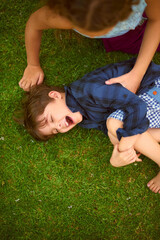 Above, children and tickling for fun outdoor for playful game, bonding together and sensory growth...