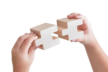 Business success partnership or teamwork concept. Hands merging wooden puzzle pieces.