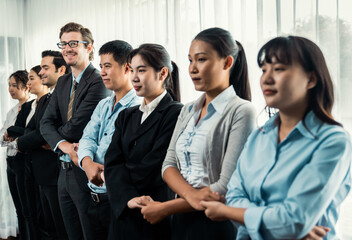 Obraz premium Modern diversity and multicultural company, business people joining hand together and standing in line, shared commitment to collaboration and cooperation concept background. Meticulous