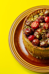 A small cake with berries on top of it