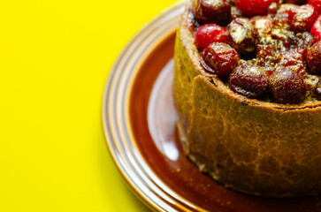 A small cake with berries on top of it