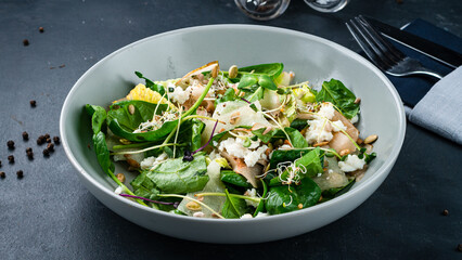 Green salad with cream cheese, lettuce, pear, spinach, microgreens, pumpkin and sunflower seeds.