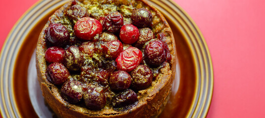 A small cake with berries on top of it