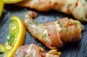 A plate of food with bacon and shrimp, including a lemon wedge
