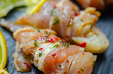 A plate of food with bacon and shrimp, including a lemon wedge