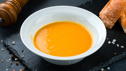 Pumpkin cream soup with bread and spices.