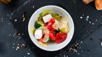 Salad of fresh tomato, sweet pepper, lettuce, red onion and feta cheese.