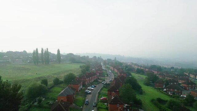 Aerial video provides an overview of Dewsbury Moore Council estate in the UK, highlighting red-brick housing and the industrial Yorkshire