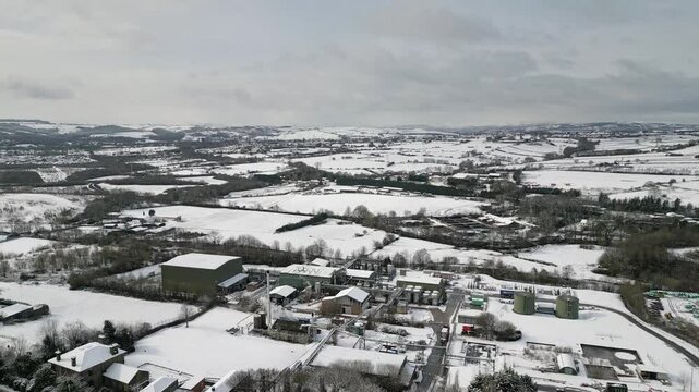 Aerial Drone Video Footage showing a snowy landscape in a suburban UK town.