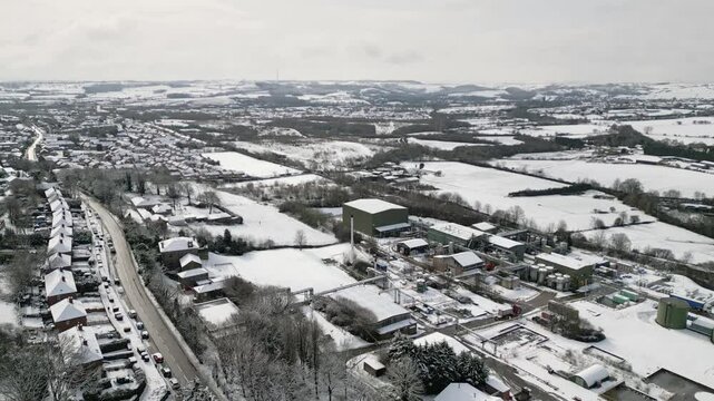 Aerial Drone Video Footage showing a snowy landscape in a suburban UK town.