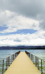 Fototapeta premium dock in the middle of the water with Andean mountains in the background