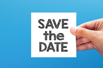 Save the date. Save the date message with white note paper on blue background.