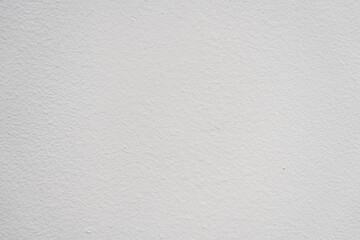 Plain white wall texture with subtle variations in shade, ideal for backgrounds in various design projects