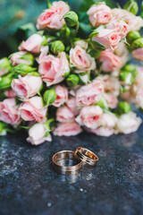 Wedding rings for newlyweds on a background of flowers. Precious wedding rings