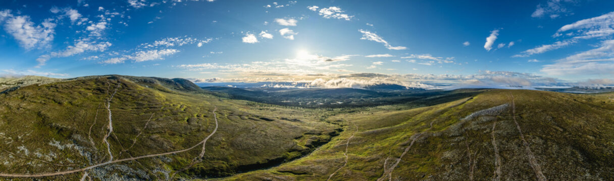 Aerial panorama of Nipfj&auml;llet St&auml;djan National Park at sunrise in Idre Dalarna Sweden, revealing scenic hiking trails leading to Mulen and Lillnipen Mountain peaks amid breathtaking landscapes