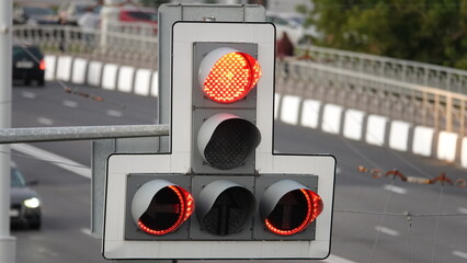 Red traffic signal at a large intersection in a city, metropolis, highway. Only the red signal on...