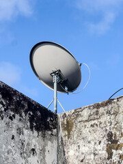 BIRD next to a satellite dish antenna