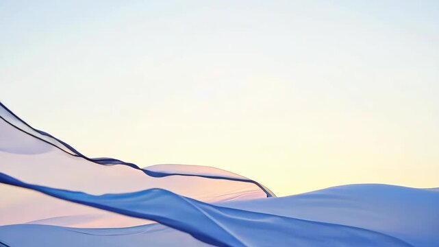 Light transparent fabric fluttering in the breeze at sunset over a serene landscape