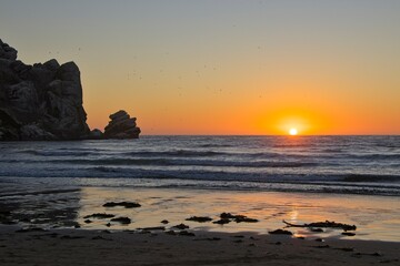 The sun sets over the Pacific in Morro Bay, California
