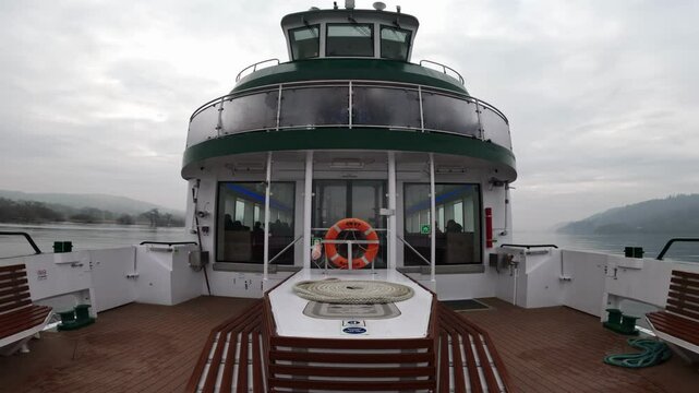 Lake Windermere cruise Ship full of passengers on a foggy, misty morning.