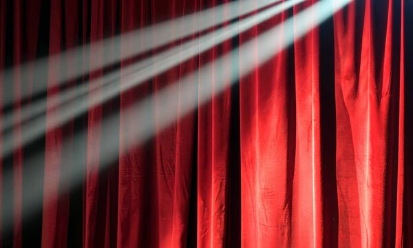Dramatic red theater curtains with light streaks