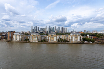 Fototapeta premium Daytime cityscape view of London, England, from the Thames River with cloudy sky