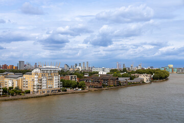 Daytime cityscape view of London, England, from the Thames River with cloudy sky