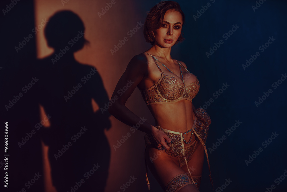 Sticker Young slim woman in lingerie studio portrait dark portrait with warm light