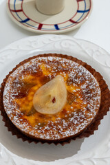 Homemade baked pear cake with caramel almond custard close up, traditional sweets of Perigord, Dordogne, France