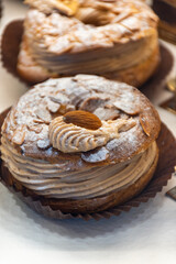 Freshly baked stuffed sweet Paris-Brest pastries in traditinal French bakery in small village in Provence